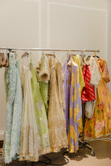 Rack displaying a collection of vividly colored, ornate garments, exuding elegance and cultural richness, promising a captivating and visually stunning experience.