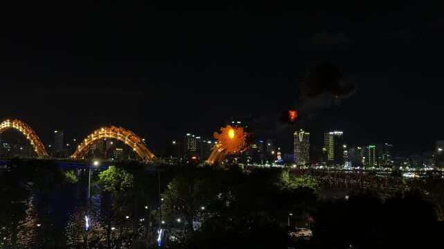 Fiery dragon bridge illuminating nighttime da nang skyline, casting vibrant reflections across han river waters, highlighting architectural marvel in central vietnam