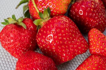 Close-up of ripe juicy strawberries with natural defects