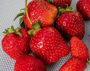 Close-up of ripe juicy strawberries with natural defects