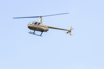 Silver Helicopter in Flight on Clear Blue Sky   Srebrny helikopter lecący na tle czystego błękitnego nieba © Adrian White