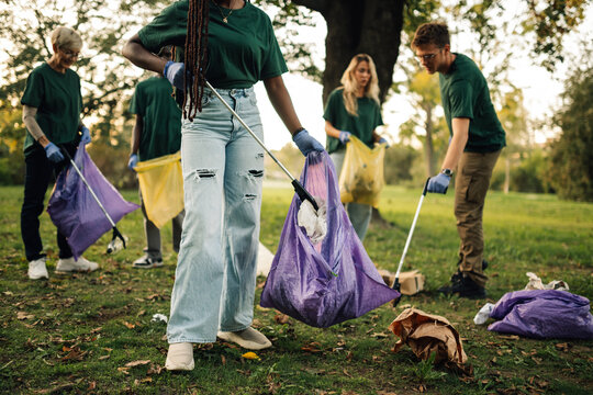 Group of volunteers collecting garbage in park