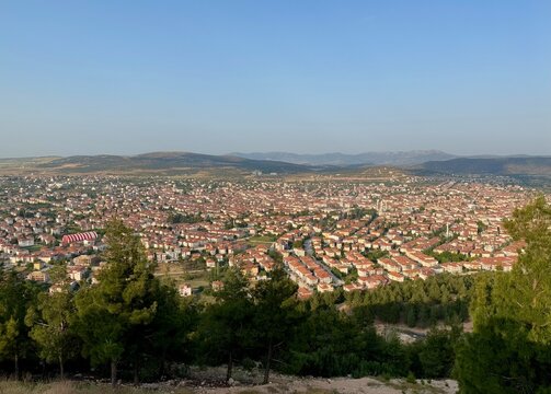 View from the mountain to the evening town of Korkuteli, Antalya. Panoramic view of the city. Houses with rooftops
