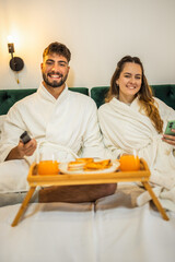 Relaxed Vacation Morning – Couple Watching TV in Bed