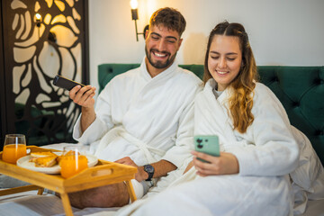 Relaxed Vacation Morning – Couple Watching TV in Bed