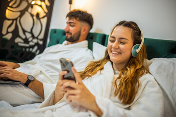 Modern Couple in Bed – Separate Digital Worlds, Shared Space