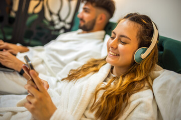 Modern Couple in Bed – Separate Digital Worlds, Shared Space