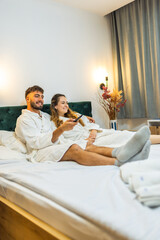 Relaxed Vacation Morning – Couple Watching TV in Bed