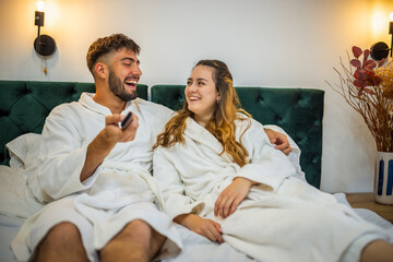 Relaxed Vacation Morning – Couple Watching TV in Bed