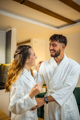 Couple in Bathrobes Looking at Each Other in Hotel Room