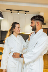 Couple in Bathrobes Looking at Each Other in Hotel Room