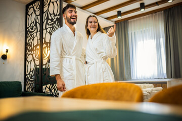 Couple in Bathrobes Admiring Hotel Room Interior