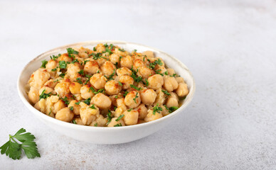 Traditional Lebanese dish Balila or msabaha - warm chickpeas with spices and olive oil on a white.