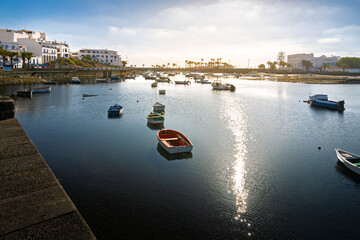 Small fishing boats float in the Charco de San Gines seawater lagoon at the seaside Spanish town of Arrecife, Lanzarote Island, Spain, in the Canary Islands.