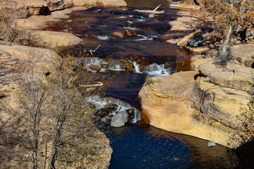 Photo of stream flowing through a rocky canyon in the desert area of the American Southwest