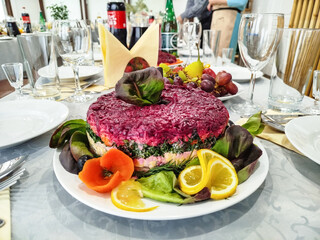 Herring under a fur coat on table