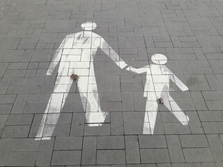 The Parent and Child Walkway Symbol Depicted on the Pavement is a Meaningful Design