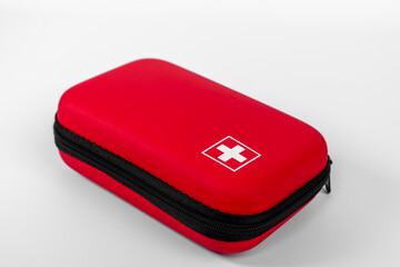 Red protective case with a white cross symbol resting against a plain background highlighting its...