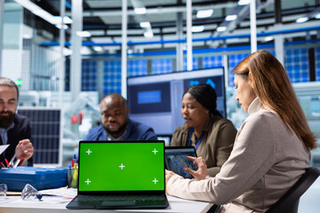 Shareholders in production plant doing doing research on chroma key laptop. Investors and factory management analyzing strategies for equipment manufacturing expansion using green screen notebook © DC Studio