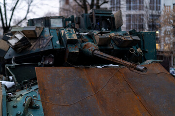 Rusty military vehicle on city street with winter setting in urban area during overcast day