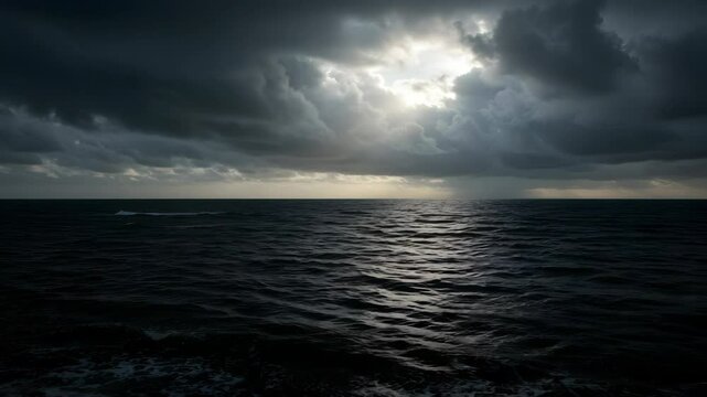 Moody Seascape with Ominous Storm Clouds Dark Blue Sea and Patch of Sunlight Breaking Through Creating a Dramatic Reflection