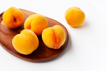 Fresh ripe apricots on a white background.