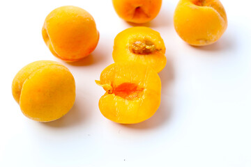 Fresh ripe apricots on a white background.