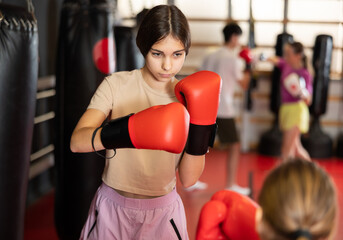 Teen girls got into fight during boxing training session. Opponent punches enemy with feet and...
