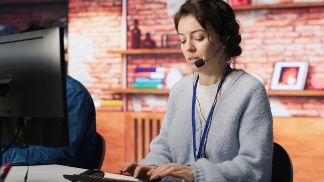 Call center employee handling customer complaints, offering helpful solutions to their concerns. Customer service agent providing helpful information related to products or services, camera A