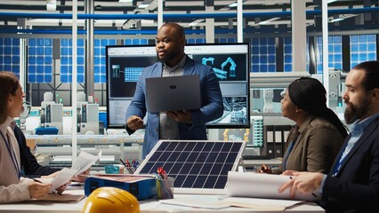 Investors in photovoltaics plant analyze market trends on laptop to determine investment...