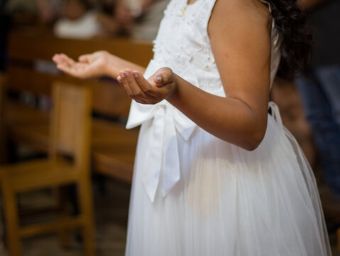 Young Girl in White Dress with Open Hands