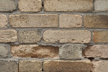 Old brick wall problem and construction industry. Old wall with bricks. Crack and holes in a brick wall.	