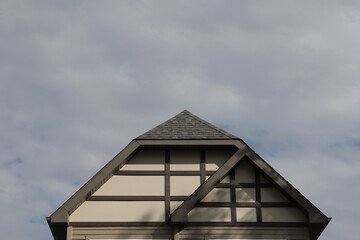 A view of the top of an old wooden house. Architecture and old house with a roof.
