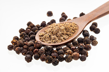 Black peppercorns in a wooden spoon - Piper nigrum