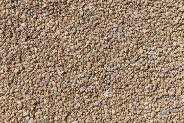 A beautiful texture of path or wall of orange and yellow stones is in the park