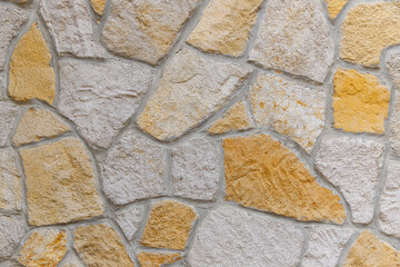 A Beautiful Textured Stone Wall Featuring Warm Tones That Enhance Its Aesthetic Appeal