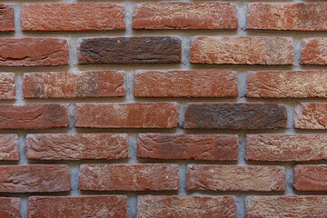 A detailed closeup shot showcasing a beautiful textured brick wall featuring warm colors
