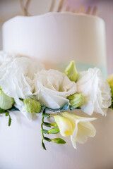 An Elegant Wedding Cake Beautifully Adorned with Fresh White Flowers for Special Events