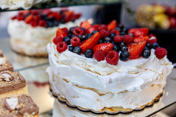 Indulge in a Delicious Pavlova adorned with an assortment of Fresh Berries and Cream