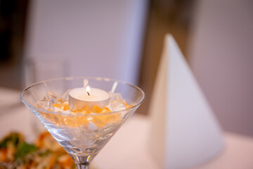 A Beautiful and Elegant Table Setting Featuring a Candle and Other Decorative Elements