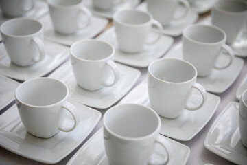 An Elegant Set of White Coffee Cups on Plates Perfect for Stylish Gatherings and Events
