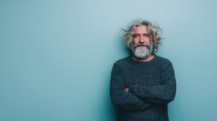 Confident Older Man with Curly Hair and Beard Against a Light Blue Background