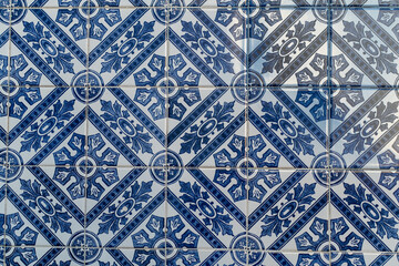 Azulejo tiles showcase a traditional Portuguese design with detailed patterns in blue and white. These tiles are commonly found adorning buildings and streets across Portugal. © Andrii