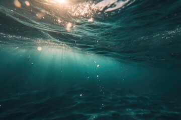 Sunbeams pierce turquoise underwater depths