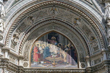 Close-up of mosaic and sculpted arch above the main portal of Florence Cathedral, Tuscany, Italy