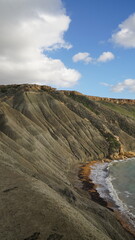 Coastal view over Malta&rsquo;s horizon, capturing vivid skies, golden reflections on the sea, and silhouetted landscapes