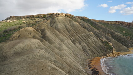 Coastal view over Malta&rsquo;s horizon, capturing vivid skies, golden reflections on the sea, and silhouetted landscapes