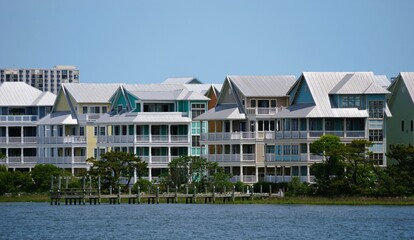 Colorful waterfront homes line the tranquil waterway, showcasing a vibrant coastal community along Assawoman Bay, Ocean City, Maryland, U.S.A