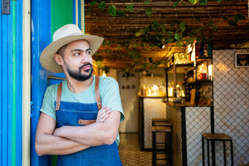 Owner of a small charming bar in South America, looking away