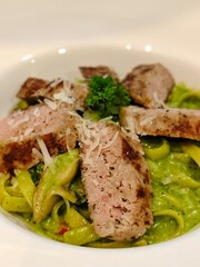 Fettuccine and sausages with pesto sauce